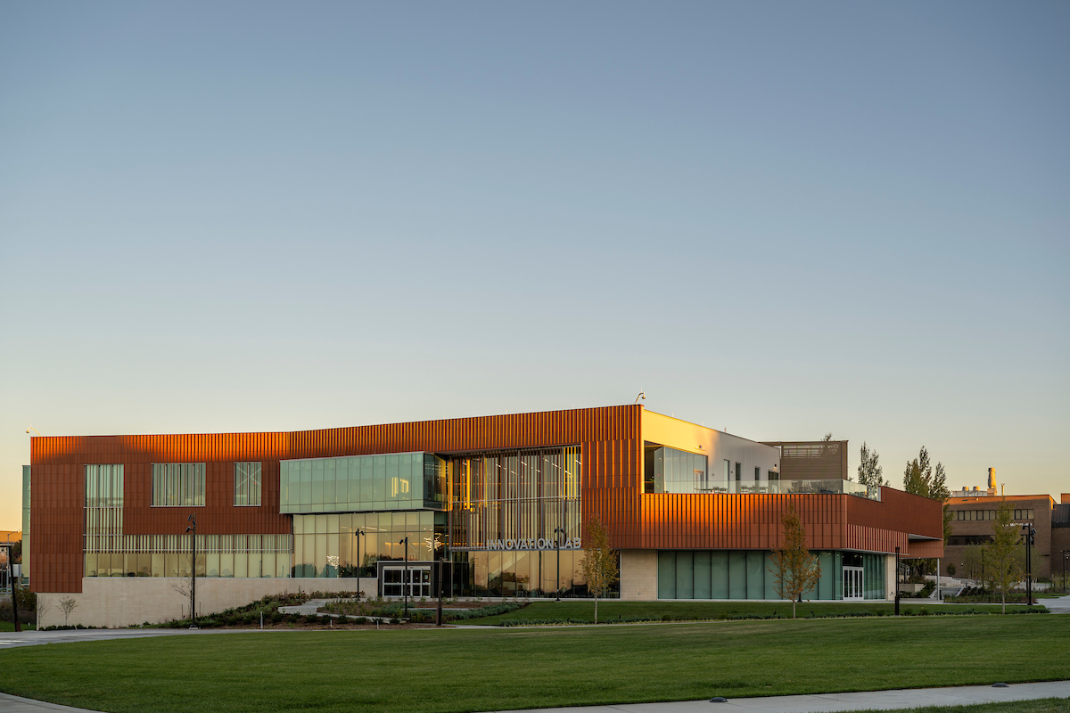 A modern two-story building with glass and orange paneling, labeled 